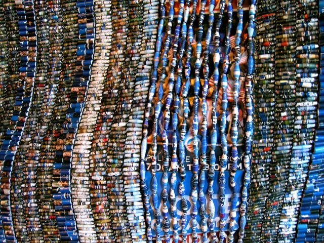 Beads re-fabricated from Barack Obama presidential campaign literature<br>
243.8 cm x 304.8 cm / 96” x 120”<br>
In collaboration with Sanaa Gateja and the Kwetu Afrika Women’s Association Angels, Uganda