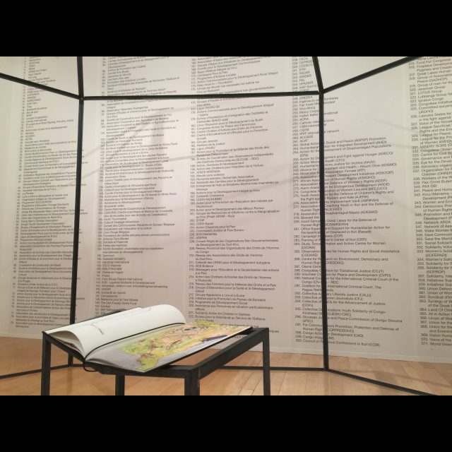 Installation at 13th Lyon Biennale (macLYON)<br>
Metal sculpture, 400 x 550 cm<br>
Hunting & Collecting, 32-page artist’s book (37.5 x 31 cm)<br>
Photographic print listing North Kivu and South Kivu NGO’s