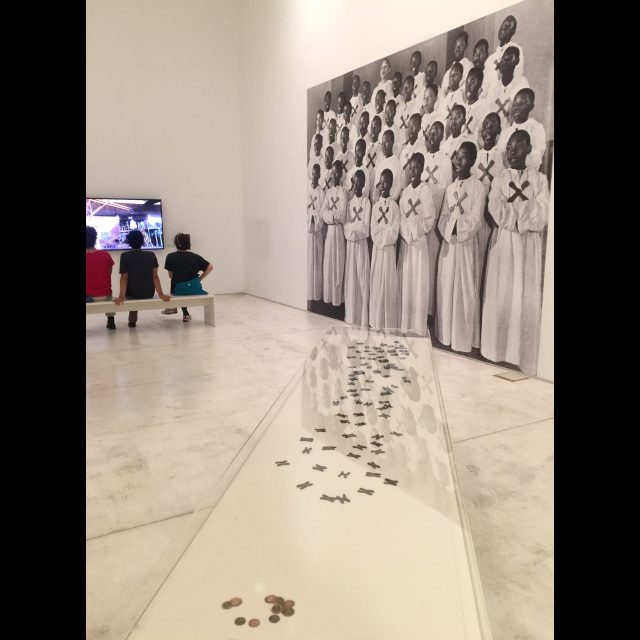 Tales of the Copper Cross Garden: Episode I (2017), installation at documenta 14, Athens<br>
Video, photographs, copper plate, copper crosses, and coins
