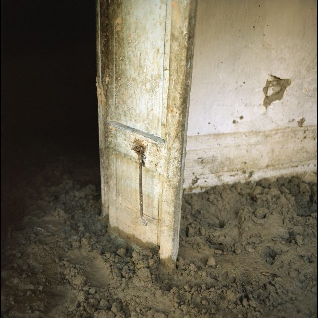 The house of Tibo Jean Fritzner in Decade in southeast Haiti is full of mud after being flooded and damaged by Hurricane Gustav. During the hurricane season of 2008 Haiti was subjected to four destructive hurricanes in the space of twenty days. This increasing severity and quantity of hurricanes is one of the effects of climate change. "We were very scared when the hurricane came. It was very windy and there were corrugated iron sheets flapping noisily. There was so much noise Ð the wind, and people crying, people shouting and running in the street. Someone came to help my mother get away, and someone else helped me with the pigs and goats. So then we left the house and fled. We had no idea whether the house would still be there afterwards - we just saved ourselves. This is the highest the water has ever risen. I've never seen a flood like it."<br>
27 1/2” x 27 1/2 / 70 x 70 cm<br>
48” x 48” / 122 x 122 cm<br>
71” x 71” / 180 x 180 cm<br>
Edition: 3 + 1 AP