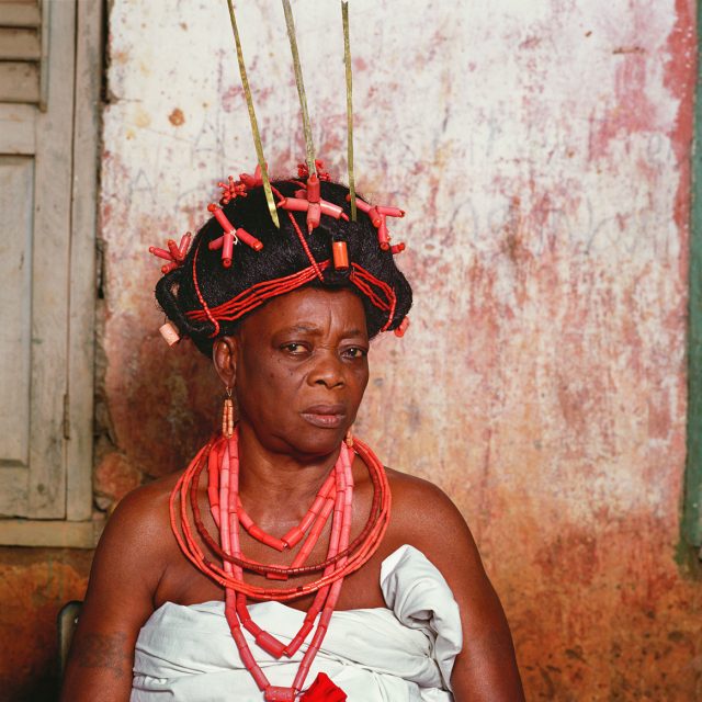 Okao Aiwerioghene is the senior wife of the Aiwerioghene, a senior town chief in Benin. Her prominence entitles her to multiple strands of red beads and an elaborate coiffure decked with beads and ornaments.
Series: <i>Kings, Chiefs, and Women of Power</i><br>
Chromogenic print on Fujiflex Crystal Archive paper<br>
30” x 30”; Edition: 5 + 2 AP<br>
50” x 50”; Edition: 3 + 1 AP