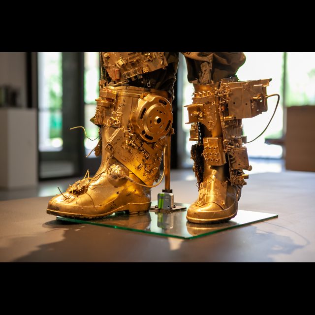 <i>SPACEWALKER GEN-9</i>, 2020-2022 (detail)<br>
SCrashed_Capital series<br>
Multimedia – electronic circuits, fabric, wire, found objects, and gold spray paint<br>
Photo © Rachel Kabukula