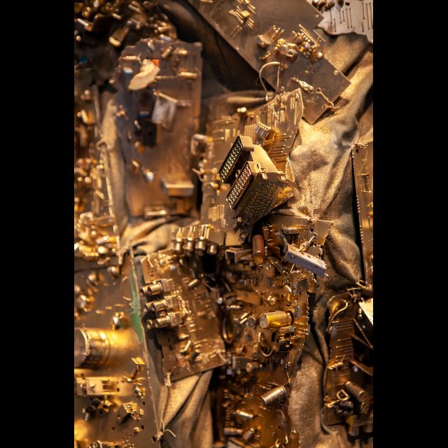 <i>SPACEWALKER GEN-9</i>, 2020-2022 (detail)<br>
SCrashed_Capital series<br>
Multimedia – electronic circuits, fabric, wire, found objects, and gold spray paint<br>
Photo © Rachel Kabukula