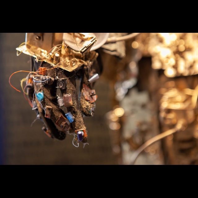 <i>SPACEWALKER GEN-9</i>, 2020-2022 (detail)<br>
SCrashed_Capital series<br>
Multimedia – electronic circuits, fabric, wire, found objects, and gold spray paint<br>
Photo © Rachel Kabukula