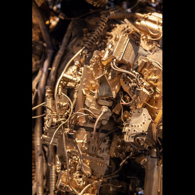 <i>SPACEWALKER GEN-9</i>, 2020-2022 (detail)<br>
SCrashed_Capital series<br>
Multimedia – electronic circuits, fabric, wire, found objects, and gold spray paint<br>
Photo © Rachel Kabukula