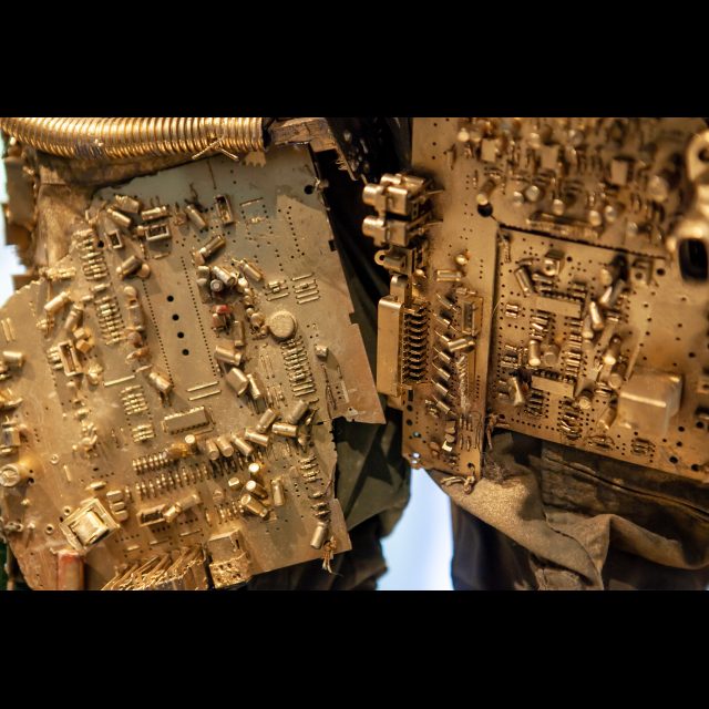 <i>SPACEWALKER GEN-9</i>, 2020-2022 (detail)<br>
SCrashed_Capital series<br>
Multimedia – electronic circuits, fabric, wire, found objects, and gold spray paint<br>
Photo © Rachel Kabukula