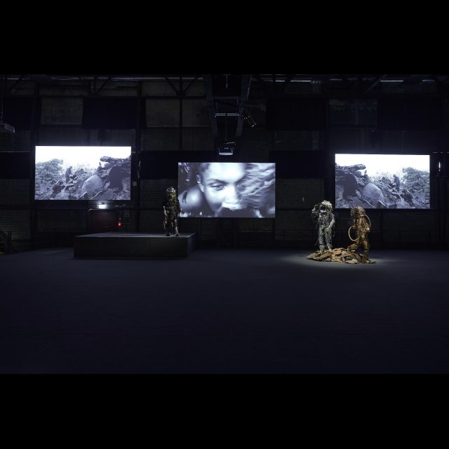 multimedia installation<br>
3-channel video <i>0,55 Grams Raw Material track #01 (stay tuned), <i/>and three performance suits, <br> <i>Unheimliche Spacewalker (The Haunting Strangeness of Borders)<i/>, <i>Refracted Reality Spacewalker<i/>, and <i>Rising and Falling Skies Spacewalker<i/>.<br>
Photos: Hans-Georg Merkel / Weltkulturerbe Völklinger Hütte<br>