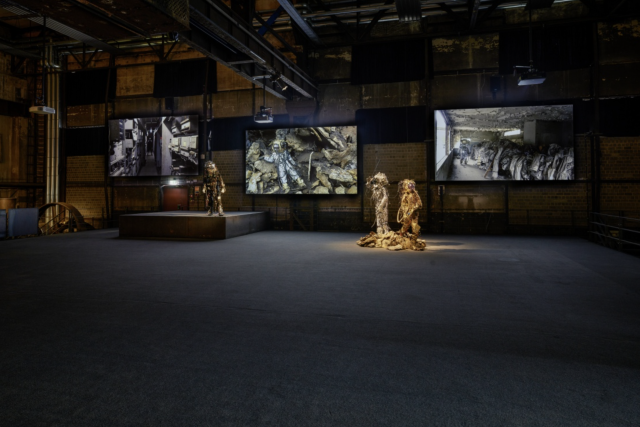 multimedia installation<br>
3-channel video <i>0,55 Grams Raw Material track #01 (stay tuned), <i/>and three performance suits, <br> <i>Unheimliche Spacewalker (The Haunting Strangeness of Borders)<i/>, <i>Refracted Reality Spacewalker<i/>, and <i>Rising and Falling Skies Spacewalker<i/>.<br>
Photos: Hans-Georg Merkel / Weltkulturerbe Völklinger Hütte<br>