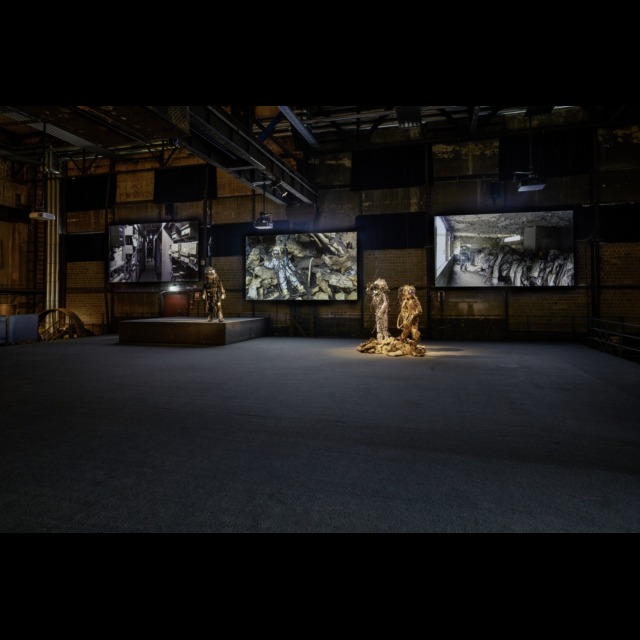 multimedia installation<br>
3-channel video <i>0,55 Grams Raw Material track #01 (stay tuned), <i/>and three performance suits, <br> <i>Unheimliche Spacewalker (The Haunting Strangeness of Borders)<i/>, <i>Refracted Reality Spacewalker<i/>, and <i>Rising and Falling Skies Spacewalker<i/>.<br>
Photos: Hans-Georg Merkel / Weltkulturerbe Völklinger Hütte<br>