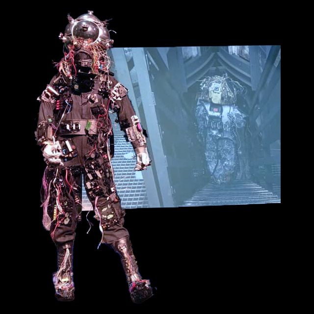 multimedia installation (detail)<br>
3-channel video <i>0,55 Grams Raw Material track #01 (stay tuned), <i/>and performance suits<br>
Photos: Hans-Georg Merkel / Weltkulturerbe Völklinger Hütte<br>